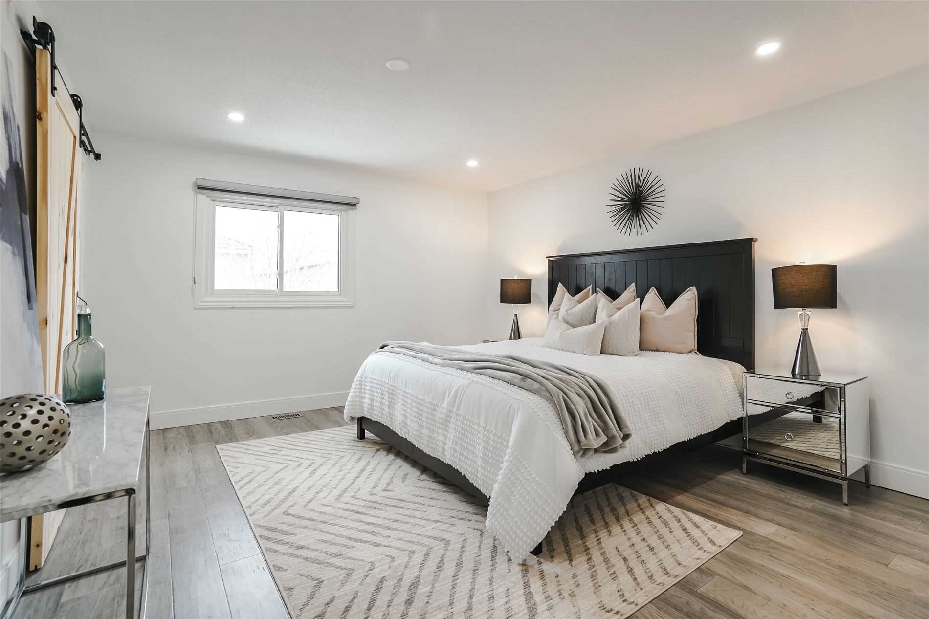 Renovated primary bedroom with modern flooring and neutral finishes