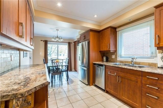 Original narrow kitchen with wood cabinets and ceramic floor