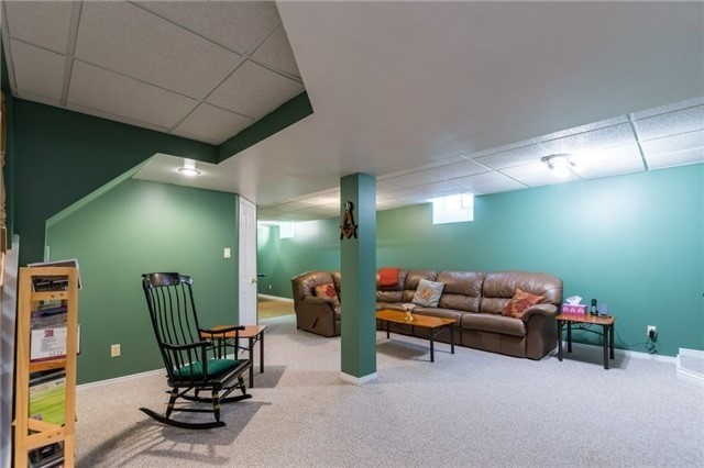 Open green basement recreation room before renovation
